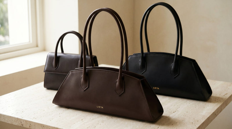The Lungo in black Italian Buttero leather on a near-white studio background — a structured silhouette in the same category as DeMellier's signature Mini Venice and Tokyo styles.