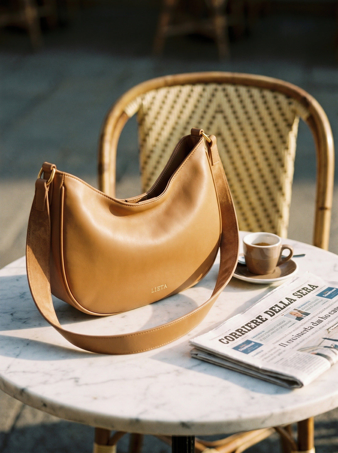 The Abbraccio in Camel — on a marble bistro table