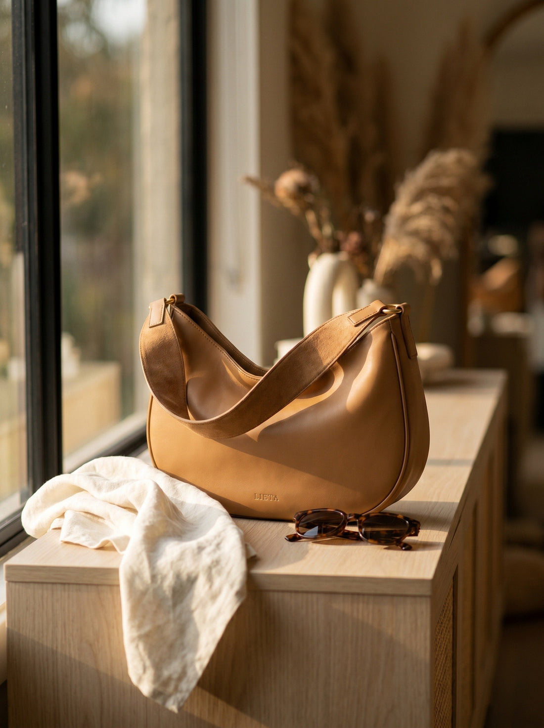The Abbraccio in Camel — by a window with linen